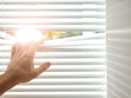 young-man-opening-window-blinds-closeup-space-text-139942111